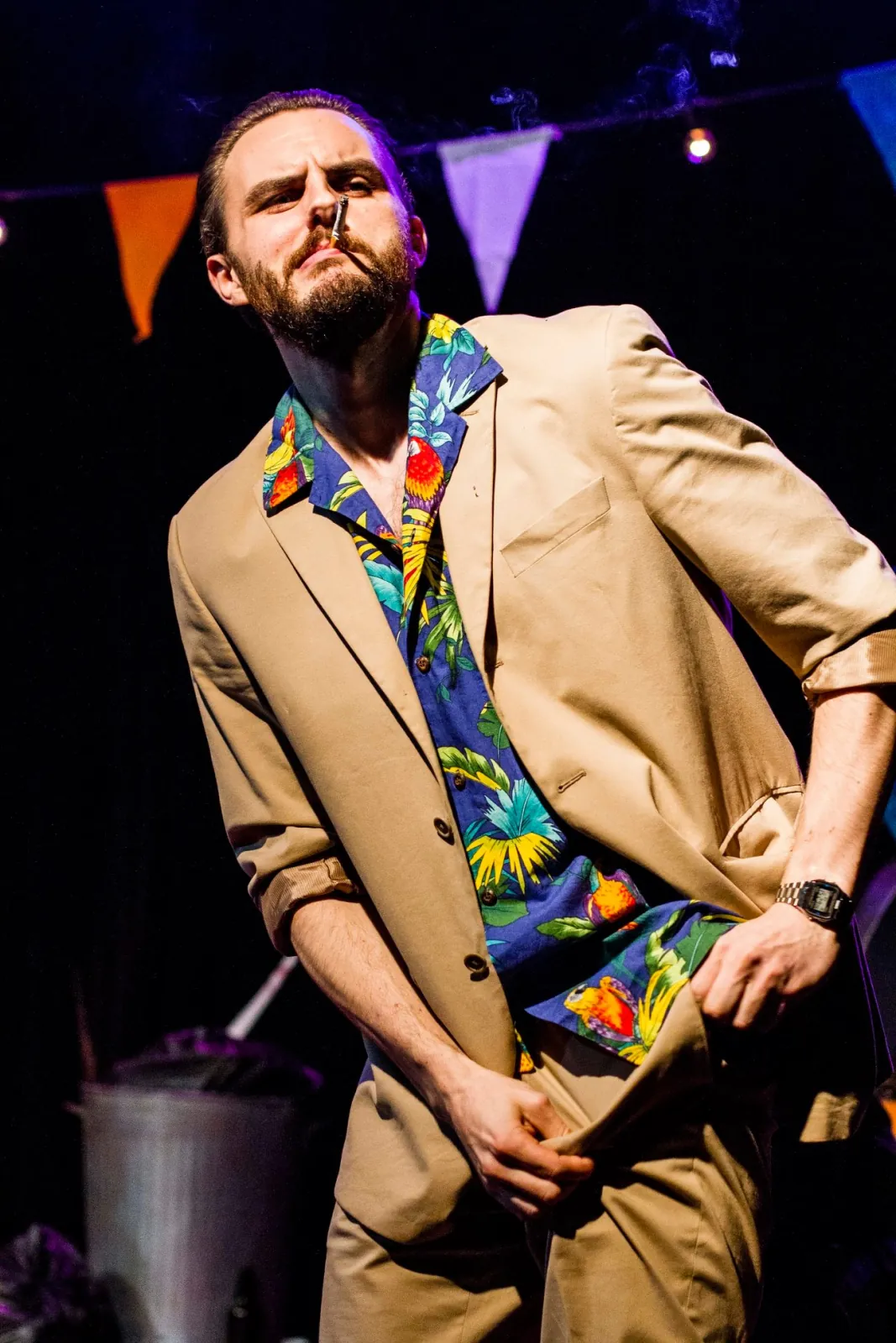 Danny Solomon on stage — tropical shirt, smoking, low angle