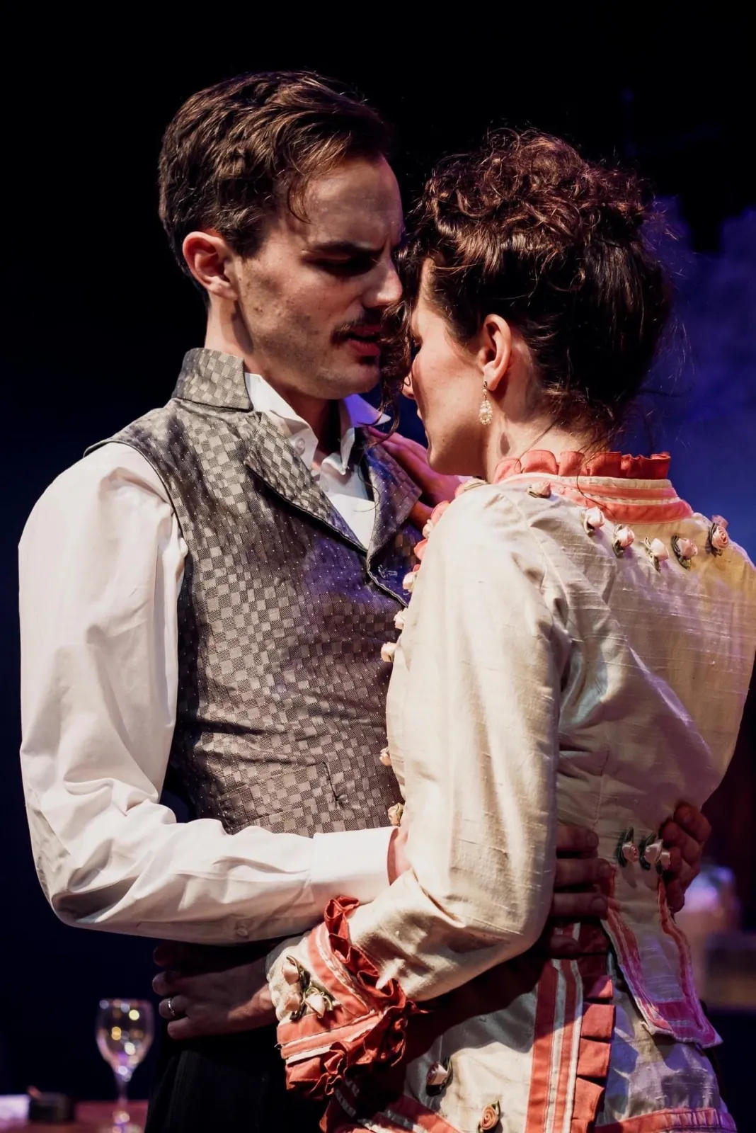 Danny Solomon on stage — period costume, close embrace