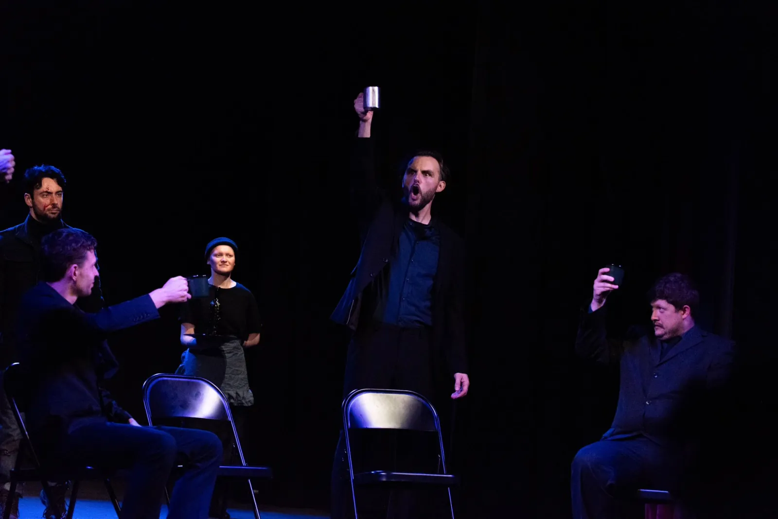 Danny Solomon on stage — group toast, folding chairs