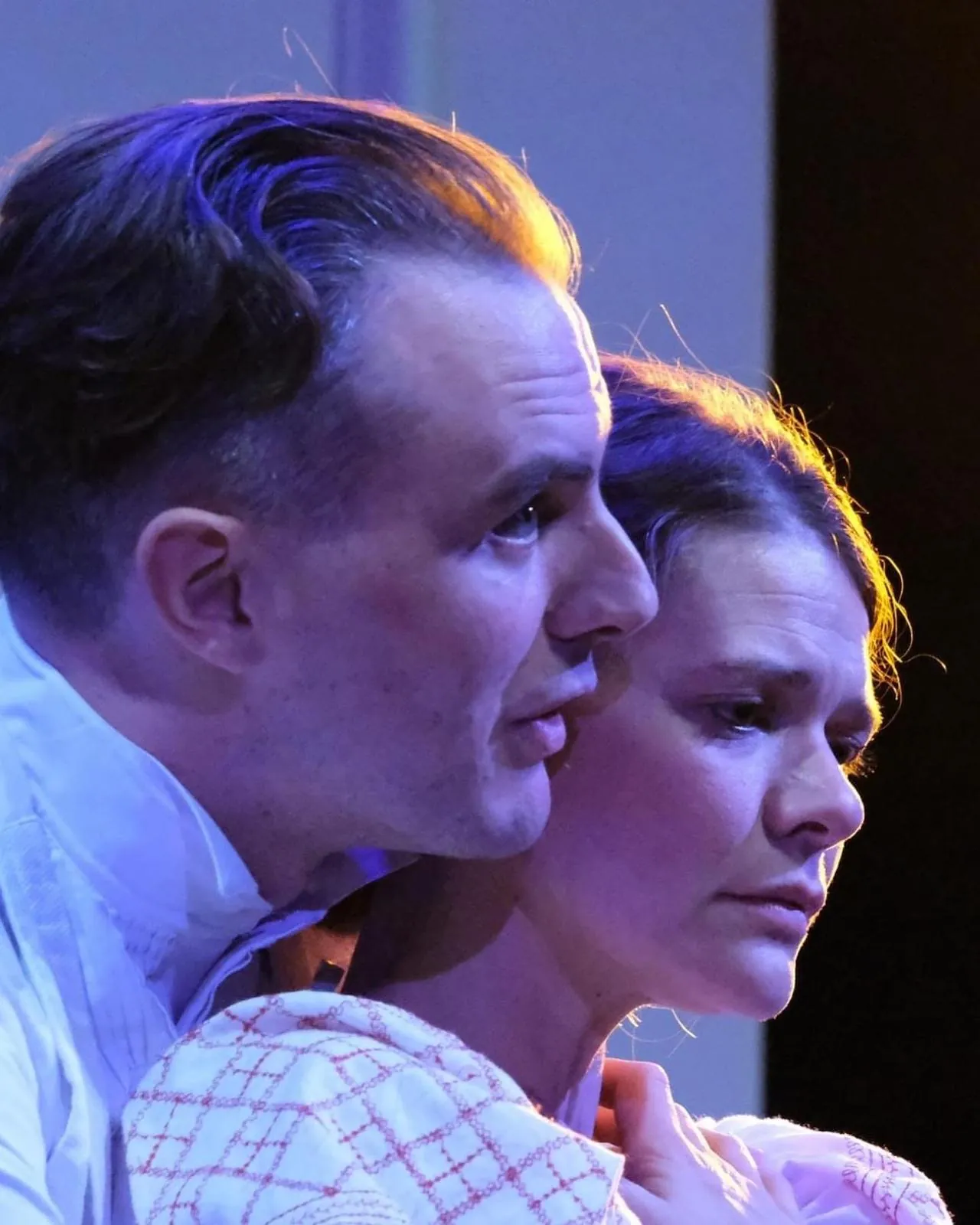 Danny Solomon on stage — close profile with a co-star