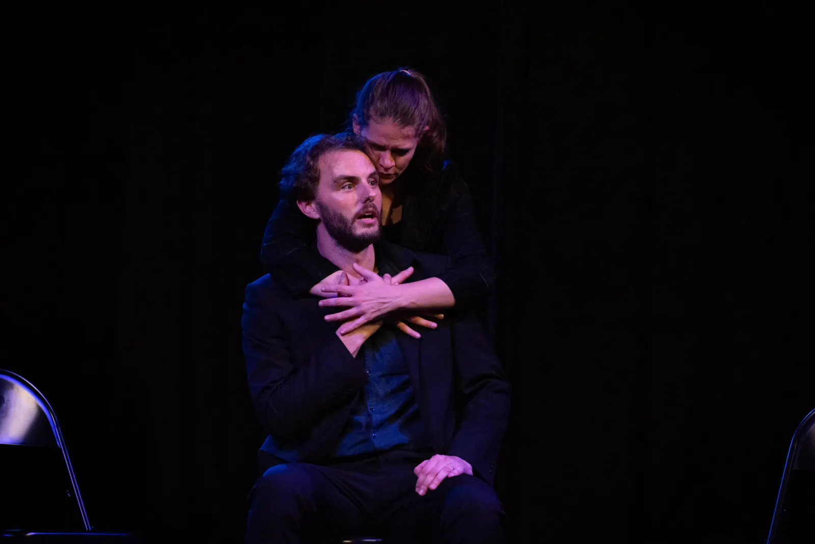 Danny Solomon on stage — pointing, glass in hand