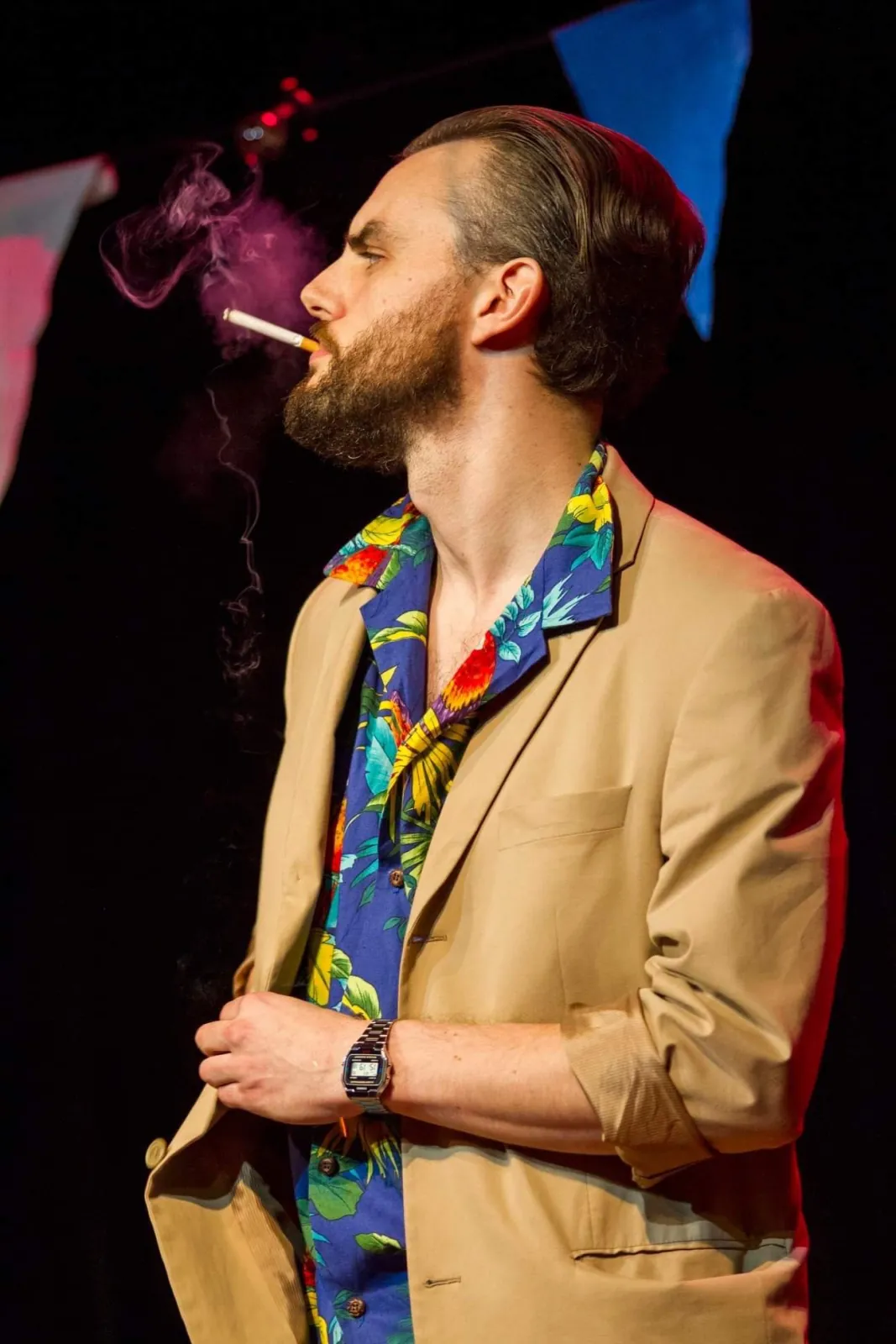 Danny Solomon on stage — smoking, tropical shirt, profile